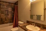 The en-suite master bathroom features beautiful upgrades and a bath/shower combo